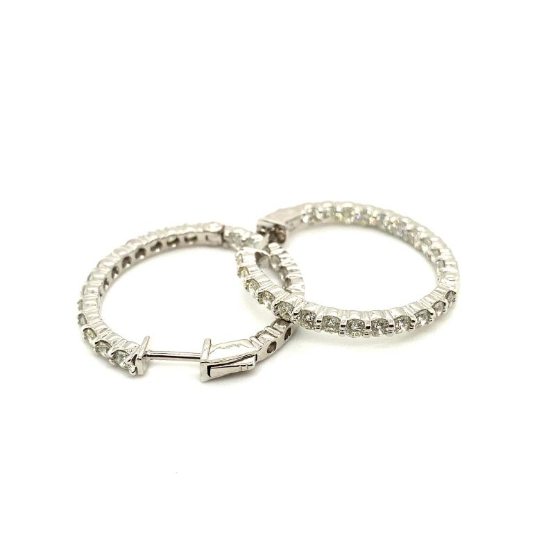 two white gold hoop earrings with diamonds