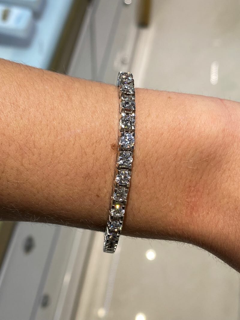 a woman's arm with a diamond bracelet on it