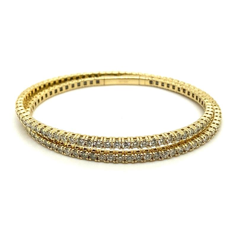 a gold bracelet with three rows of diamonds
