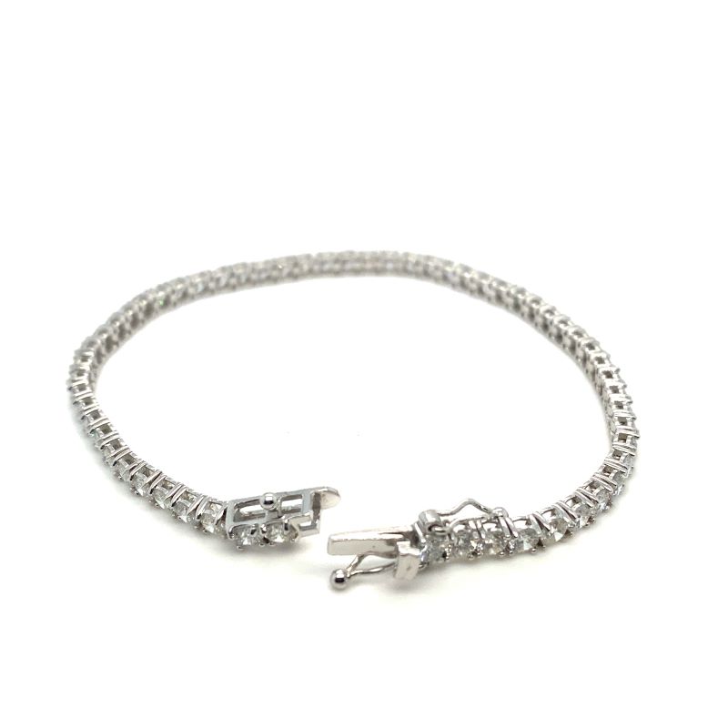 a silver bracelet with two charms on it