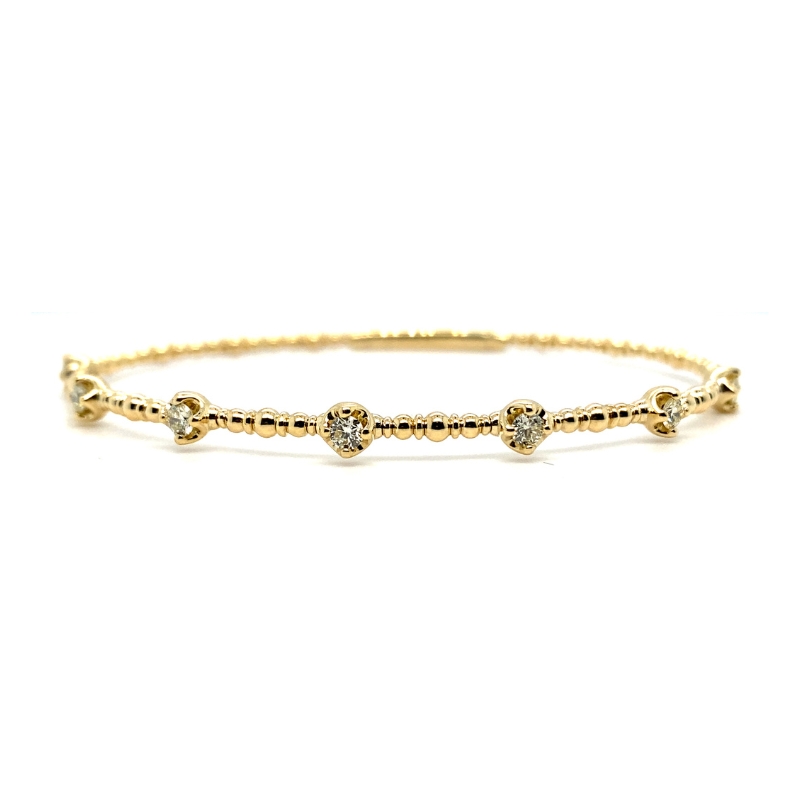 a gold bracelet with three stones on it
