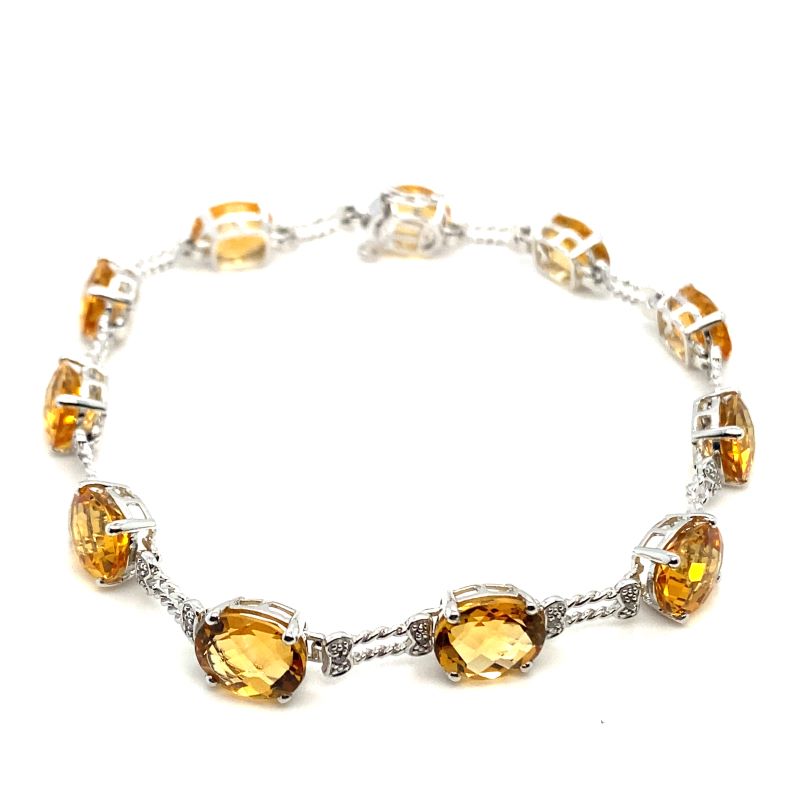 a silver bracelet with yellow glass beads