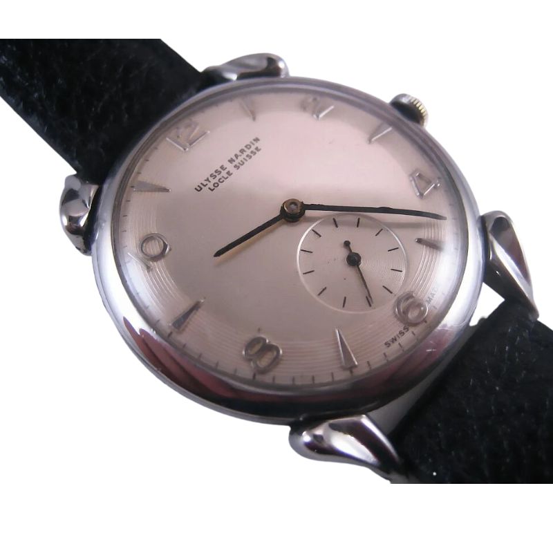 an old watch is sitting on a black leather strap