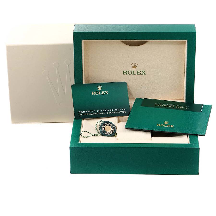 a rolex watch in a green box