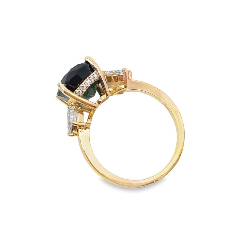 a gold ring with black and white stones