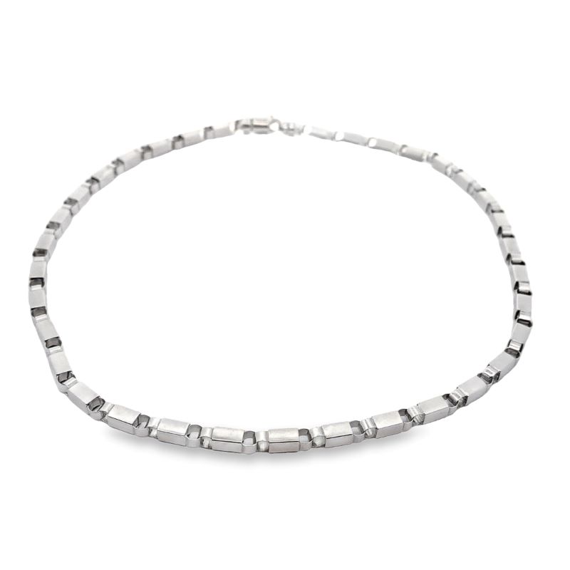a silver necklace on a white background