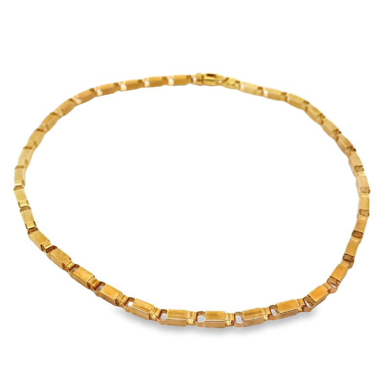 a gold necklace with square beads on a white background