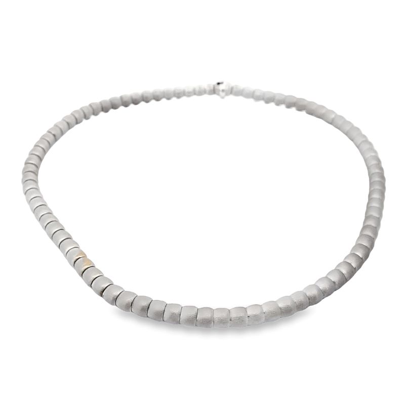 a white necklace on a white background