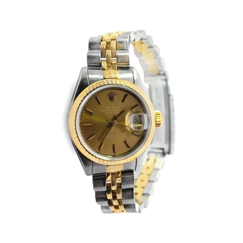 a watch with two tone gold dials